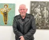  ?? BOB CHIARITO/FOR THE SUN-TIMES ?? Jon Langford is photograph­ed with two of his paintings on exhibit at The Dime, 1513 N. Western Avenue.