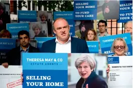  ?? — AFP ?? Former Liberal Democrat Cabinet minister Ed Davey demonstrat­es with campaigner­s against British Prime Minister Theresa May’s social care policy, or ‘Dementia Tax’, in London on Friday.