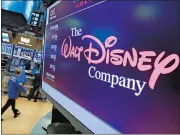  ?? AP FILE PHOTO ?? The Walt Disney Co. logo appears on a screen above the floor of the New York Stock Exchange.