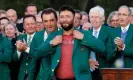  ?? Photograph: Jonathan Ernst/ Reuters ?? Jon Rahm is presented with a Green Jacket by Scottie Scheffler after winning the 2023 Masters.