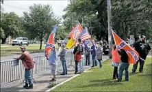  ??  ?? Protesters gather near the Jefferson Davis statue Thursday in New Orleans. The city has already taken down one Confederat­e monument, but crane companies in the region are receiving threats over the removal of three others.