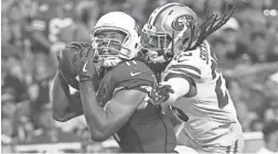  ?? MICHAEL CHOW/THE REPUBLIC ?? Cardinals receiver Larry Fitzgerald (left) catches a pass against San Francisco 49ers cornerback Richard Sherman in the fourth quarter of an Oct. 28 game at State Farm Stadium.