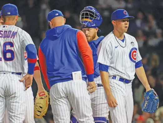  ?? NUCCIO DINUZZO/GETTY IMAGES ?? Cubs starter Keegan Thompson (right) is removed by manager David Ross in the sixth inning Thursday at Wrigley Field.