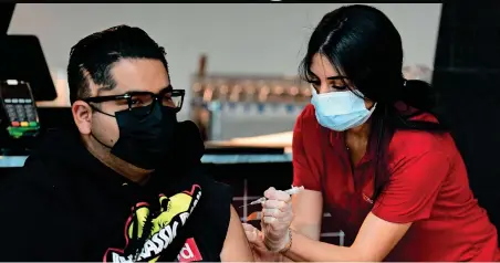  ?? AFP ?? Ricardo Sierra receives his Johnson & Johnson vaccine at a clinic setup by Los Angeles Football Club in Los Angeles, California. —