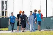  ?? WILFREDO LEE/AP ?? Migrants, some of them minors, walk outside a shelter for unaccompan­ied migrant children in Homestead, Florida.