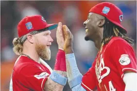  ?? AP PHOTO/DAVID J. PHILLIP ?? Cincinnati Reds' Elly De La Cruz (44) and Jake Fraley celebrate after Sunday's game against the Houston Astros Sunday in Houston. The Reds won 9-7 in 10 innings.