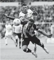  ?? OWEN HUMPHREYS PA VIA/AP ?? Arsenal’s Ben White, top, fouls Newcastle United's Callum Wilson during Newcastle’s 2-0 win in the English Premier League on Monday.