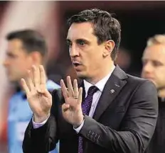  ?? AP ?? Exit wounds Valencia coach Gary Neville signals during a Champions League match against Lyon at the Mestalla stadium on Wednesday.