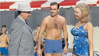  ??  ?? CUNNING SMILES: Margaret Nolan plays a poolside masseuse dismissed with a slap on the bottom in the 1964 Sean Connery as Bond film ‘Goldfinger’