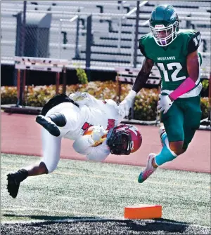  ?? PHOTOS BY CHRIS RILEY — TIMES-HERALD ?? Vallejo’s Kyree Reason flies through the air as he is brought down in the end zone after a 70-yard touchdown during the Redhawks’ 64-20 loss to Rodriguez on Friday afternoon.