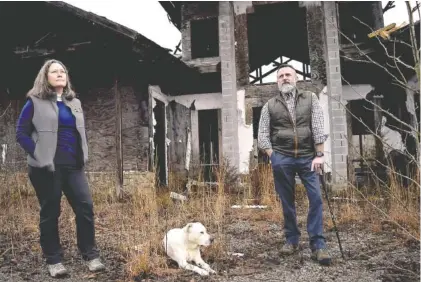  ?? PHOTO BY MARK PACE ?? Ray Knott and Patty Springer, of Southeaste­rn Cave Conservanc­y Inc., give a tour of the recently preserved Charles B. Henson Preserve at Johnson’s Cook. The structure behind them is part of what’s left of a failed developmen­t the two hope to rebuild into a park area.