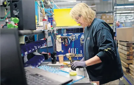  ?? [BROOKE LAVALLEY/DISPATCH PHOTOS] ?? Sandy Meutzling pieces together components at the Ametek Solidstate Controls plant in Columbus. The company supplies generator equipment and maintenanc­e to a variety of facilities from nuclear power plants to forklift battery supplies.