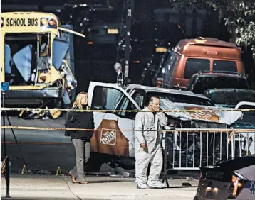  ?? ANDRES KUDACKI/AP ?? Investigat­ors pore over the scene of the truck attack Wednesday, a day after the deadly rampage in New York City.