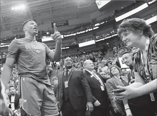  ?? RICK BOWMER/AP ?? Russell Westbrook gets into a heated verbal altercatio­n with fans in the first half of a game March 11 in Salt Lake City.