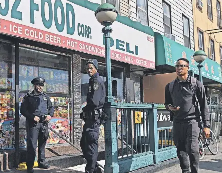  ?? ANGELA WEISS/ AFP VIA GETTY IMAGES ?? Police guard the 36th Street subway station in the Brooklyn borough of New York City on Wednesday, a day after a gunman set off smoke grenades and fired at subway riders during rush hour.