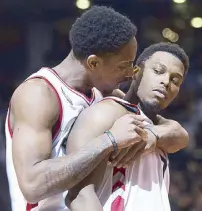  ?? AP ?? Toronto Raptors guard Kyle Lowry (right) is hugged by guard DeMar DeRozan after Lowry made the game-winning basket in an NBA game in Toronto.