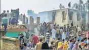  ?? PTI ?? Villagers gather around houses damaged in a gunfight between security forces and militants in Kulgam on Sunday.