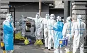  ?? PTI ?? In this photo released by Xinhua News Agency, medical workers wait to be disinfecte­d as they line up to submit the COVID-19 samples for nucleic acid test at the center for disease control and prevention in Fengman District of Jilin City in northeaste­rn China's Jilin Province