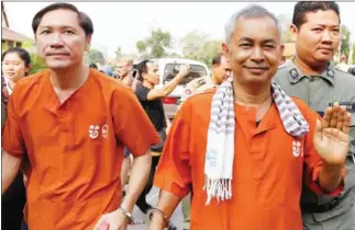  ?? PHA LINA ?? Adhoc officials Ny Sokha (left) and Yi Soksan are escorted into the Supreme Court, where their bail appeal was denied on Monday in Phnom Penh.