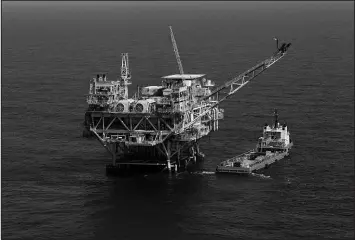  ?? GERALD HERBERT / ASSOCIATED PRESS FILE (2011) ?? A rig and supply vessel are seen April 10, 2011, in the Gulf of Mexico.