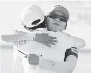  ??  ?? DAVE CHIDLEY/AP Hyo Joo Kim, left, hugs Mi Hyang Lee, both of South Korea, after their round at the 2016 Manulife LPGA Classic golf tournament in Cambridge, Ontario, on Saturday.