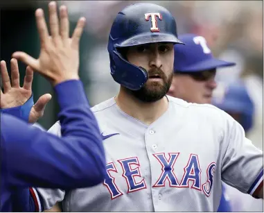  ?? CARLOS OSORIO — THE ASSOCIATED PRESS ?? Texas Rangers designated hitter Joey Gallo is greeted in the dugout after scoring during the fourth inning of a baseball game against the Detroit Tigers, Thursday, July 22, 2021, in Detroit.