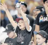  ?? MICHAEL LAUGHLIN/STAFF PHOTOGRAPH­ER ?? Miami Marlins fans shout before the start of the home opener against the Atlanta Braves.