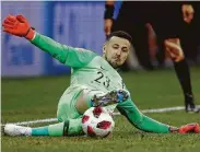  ?? Julian Finney / Getty Images ?? Croatia’s Danijel Subasic makes the save on Denmark’s Nicolai Jorgensen in the fifth round of the penalty shootout Sunday.