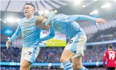  ?? AP ?? Manchester City’s Erling Haaland (right) celebrates with teammate Phil Foden after scoring their third goal during the English Premier League match against Manchester United at the Etihad Stadium in Manchester, England, yesterday. City won 3-1.