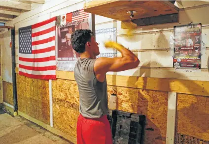  ?? Ron Cortes / Contributo­r ?? Joshua Moreno joined his father and uncle with a photo on the Golden Gloves Boxing Gym’s Wall of Champions in Fort Worth.