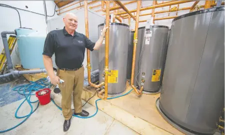  ?? FRaNCIS GEORGIAN ?? Lynn Mueller's company, Sharc Internatio­nal Systems, has installed a heat-recovery unit at Wash Out, an eco-friendly branded laundry on Annacis Island. The system collects waste water in a tank, filters it, then runs it through a heat exchanger to extract energy.