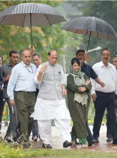  ?? — AFP ?? Home Minister Rajnath Singh and Chief Minister of Jammu and Kashmir Mehbooba Mufti arrive for a joint press conference in Srinagar on Thursday.