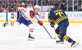  ?? KEVIN HOFFMAN/GETTY IMAGES ?? Max Domi scores his second goal of the game as the Sabres’ Evan Rodrigues tries to get in the way during Buffalo’s 4-3 win. Domi now leads the team in scoring with 10 points.