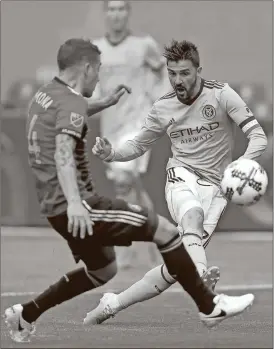  ?? Kathy Willens/ AP File ?? In this May 7, 2017, file photo, New York City FC forward David Villa (7), of Spain, takes a shot with Atlanta United midfielder Carlos Carmona (14), of Chile, defending during the first half of a Major League Soccer game, in New York. NYCFC's David...