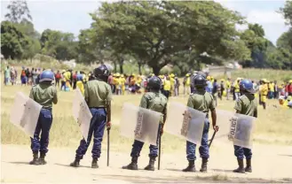  ?? ?? Police formed a human wall at Rudhaka Stadium in Marondera to block a CCC rally yesterday. Picture: Shepherd Tozvireva