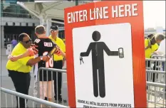  ?? Tom Uhlman / Associated Press ?? A security guard wands a Cincinnati Bengals fan outside Paul Brown Stadium prior to a preseason football game between the Bengals and Tennessee Titans, in Cincinnati, in 2013.