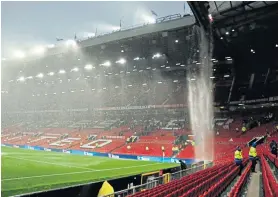  ?? ?? South Stand waterfall : Rain water cascades down from the Old Trafford roof