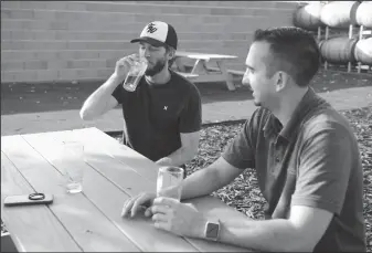  ?? BEA AHBECK/NEWS-SENTINEL ?? Ryan Kendrix, of Lockeford, and Josh Nobriga, of Lodi, enjoy beer on Thursday at High Water Brewing in Lodi. The brewery is having its grand opening on Saturday.