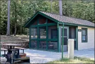  ?? Special to the Democrat-Gazette/MARCIA SCHNEDLER ?? At Lake Ouachita State Park, outdoor amenities of camper cabins include a screened porch with furniture, two grills and a picnic table.