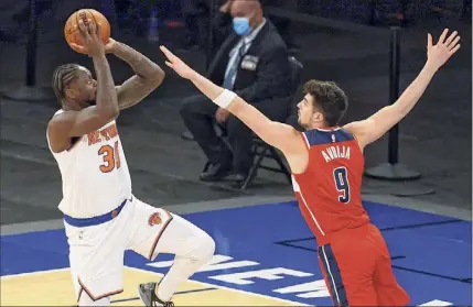  ?? Vincent Carchietta / Associated Press ?? New York Knicks forward Julius Randle shoots the ball over Washington Wizards forward Deni Avdija. Randle had 37 points to lead the Knicks.