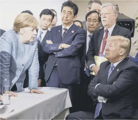  ??  ?? 0 Angela Merkel looks like she is giving Donald Trump a row while the US President exudes a toddler-like defiance