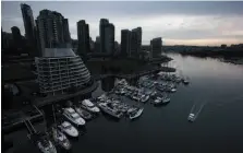  ?? CP FILE PHOTO ?? A water taxi passes by a marina and downtown condos while traveling on False Creek in Vancouver on Feb. 11, 2015.