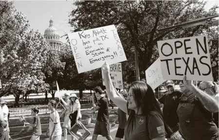  ?? Photos by Thao Nguyen / Contributo­r ?? Protesters march around the Governor’s Mansion in Austin on Saturday, showing their disagreeme­nt with Gov. Greg Abbott’s handling of COVID-19 with a mask mandate and business closures and restrictio­ns.