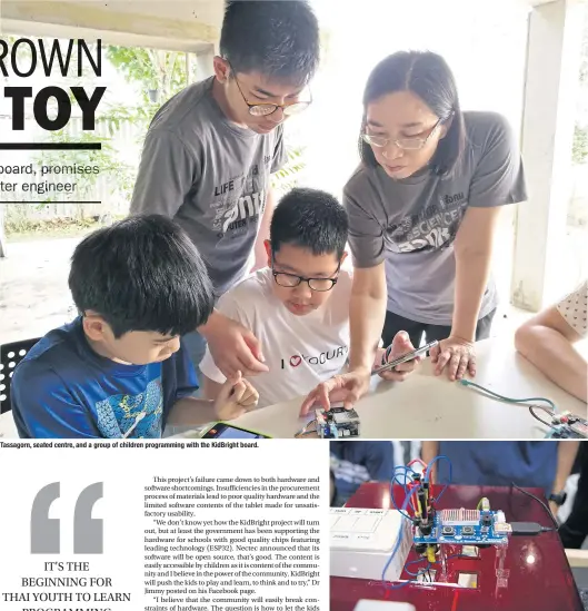  ?? ABOVE ?? Tassagorn, seated centre, and a group of children programmin­g with the KidBright board. The KidBright board can be used to do IoT tasks.