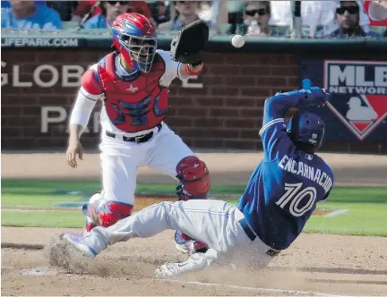  ?? BRANDON WADE/ASSOCIATED PRESS ?? Blue Jays designated hitter Edwin Encarnacio­n scores under Texas Rangers catcher Robinson Chirinos during the third inning in Game 4 of ALDS on Monday in Arlington, Tex.