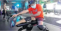  ?? JOE CAVARETTA/SOUTH FLORIDA SUN SENTINEL ?? Kunai Aswani works out at a station moved six feet away from other stations at the Get Fit Academy in Boca Raton on May 19.