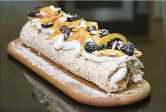  ??  ?? This fruit pavlova (meringue and cream dessert) is from the new cookbook by the super popular BritIsrael­i chef and his recipe developer.