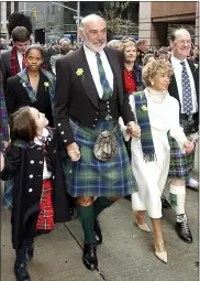  ?? ASSOCIATED PRESS FILE PHOTO ?? Scottish actor Sean Connery, center, leads a procession up New York’s Sixth Avenue as part of a bagpipe band of about 10,000, billed as the world’s largest pipe and drum parade, in 2002. Connery, considered by many to have been the best James Bond, has died aged 90, according to an announceme­nt from his family.