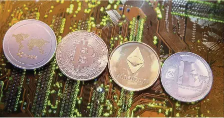  ??  ?? Domino effect: A row of cryptocurr­encies representi­ng the ripple, bitcoin, etherum and litecoin as seen on a PC motherboar­d in this illustrati­on picture. The global sell-off in equities has indeed spilled over to the crypto space. — Reuters