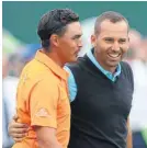  ?? AP PHOTO ?? Runners-up Rickie Fowler, left, and Sergio Garcia smile as they walk to receive their prizes at the British Open at Royal Liverpool in Hoylake, England, on Sunday.